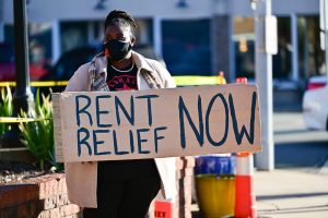 A protestor holds a "Rent Relief Now" sign during a North Carolina demonstration this month