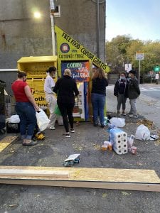 community fridge: image shows people getting food from an outdoor refrigerator