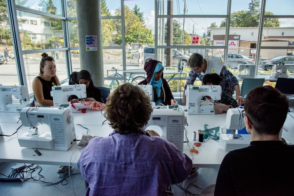 Yesler residents participate in a sewing workshop, one of several arts and culture programs available to residents.