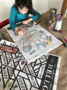 A young child uses crayons to color in an image on paper. Photo courtesy of Seattle Housing Authority.