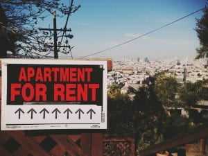 To illustrate article about rent forgiveness, photo shows "apartment for rent" sign with a row of up arrows.