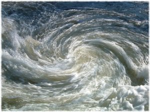 aerial photo of an ocean whirlpool, illustrating an article about the pitfalls of common assumptions underlying place-based work.