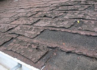 Close-up view of dilapidated asphalt roof shingles