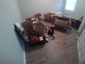 a room with boxes and suitcases, which are packed and ready to go in a single family rental in Missouri.