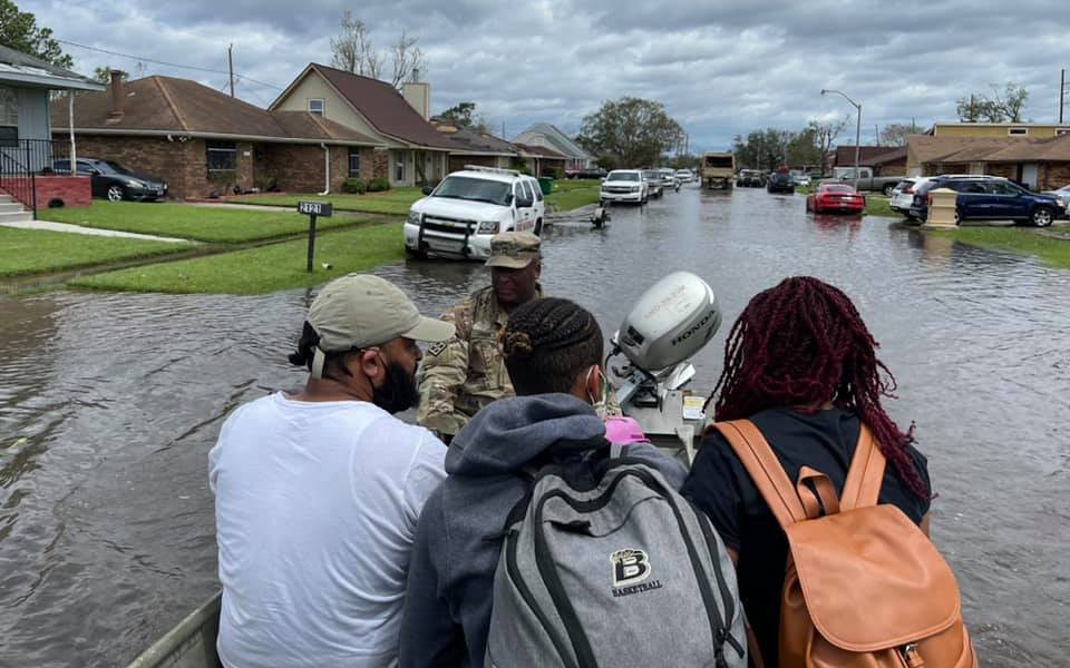 A National Guardsmen rescues three people on a boat in LaPlace, Louisiana,after Hurricane Ida brought flooding to the area.