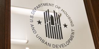 A glass door etched with a logo that reads "U.S. Department of Housing and Urban Development" in black. Changes HUD implemented in 2013 have made it harder for community housing development organizations, or CHDOs, to receive housing funds.