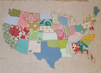 A patchwork map of the continental U.S., with a different fabric for each state. Some fabrics are solids, some prints, tending toward stylized florals. The state lines have been embroidered with contrasting thread colors.