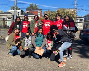 A group of people, some wearing bright red shits, pose for a photo outside. These are organizers with Louisville Tenants Union in Kentucky.