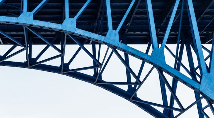 A view from below of the girders supporting a bridge.