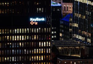Aerial view of the KeyBank building at night. Windows in it and nearby buildings are lighted.
