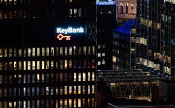 Aerial view of the KeyBank building at night. Windows in it and nearby buildings are lighted.