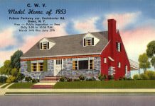 A 1953 postcard advertising a model home, a small Cape Cod with a stone front and two dormer windows. The side of the house is painted red.