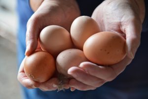 A person holding eggs.