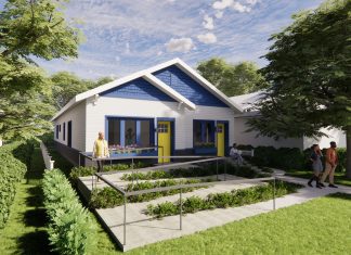 An artist's rendering of a bungalow-style two-family home in white and blue with yellow doors. At left, a winding ramp leads to one door; at right, conventional steps lead to the entrance of the other residence.