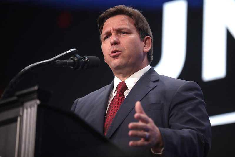 Florida Gov. Ron DeSantis speakers at a podium.