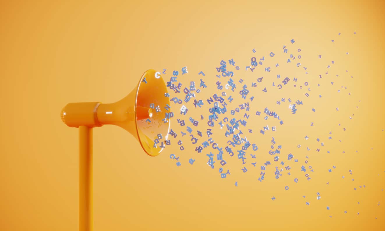 Stylized scene with a free-standing orange megaphone spewing a jumble of capital letters in shades of light blue, lavender, and white. No words are discernible in the letters. The background is a pale orange wall or screen.