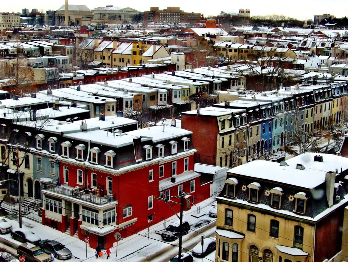 Colorful homes, old style, snow-covered, and painted in different colors, viewed from above.