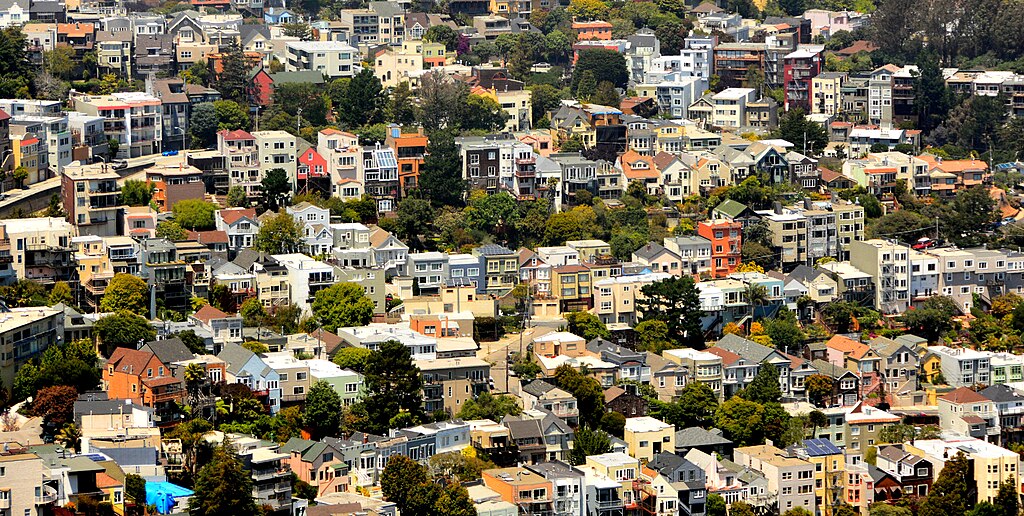 A view from above of a residential area with many colorful homes and trees