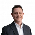 Headshot of a white man with short brown hair, wearing professional attire