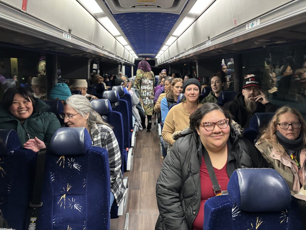 The inside of a bus filled with people.