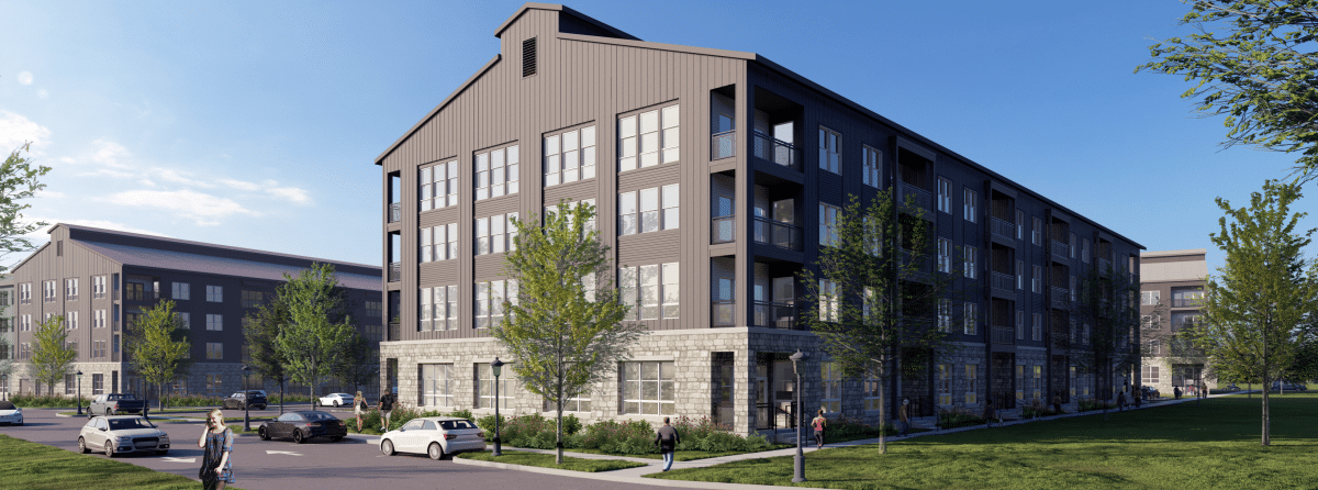 A rendering of an apartment complex featuring at least three large, four-floor gray buildings with stone exteriors at the ground levels. The buildings are set next to a parking lot on one side and a lawn with trees on the other side. Sidewalks connect the buildings. Renderings of people and cars are shown in the foreground.
