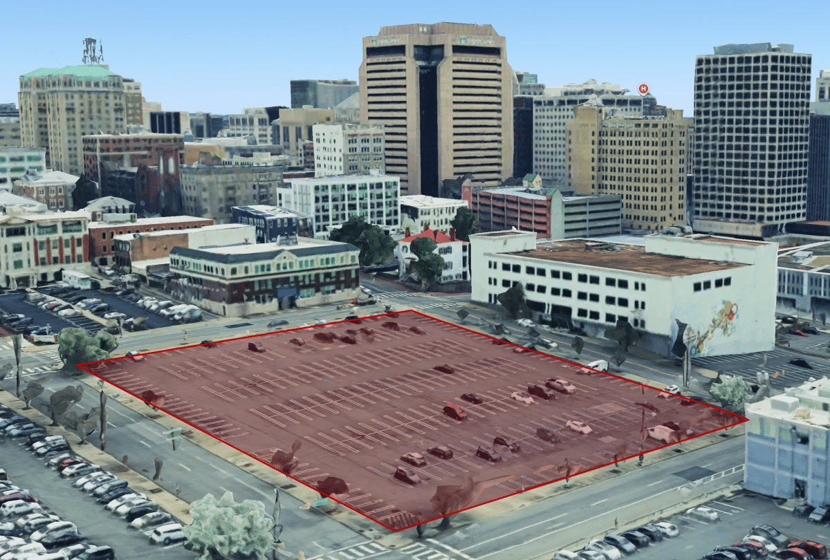A busy urban center in Richmond, Virginia, showing a large parking lot surrounded by urban buildings and parked cars.